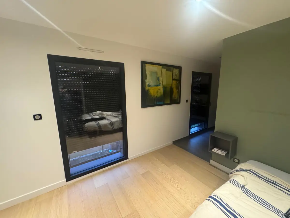 Chambre au parquet clair, propre et dégagée