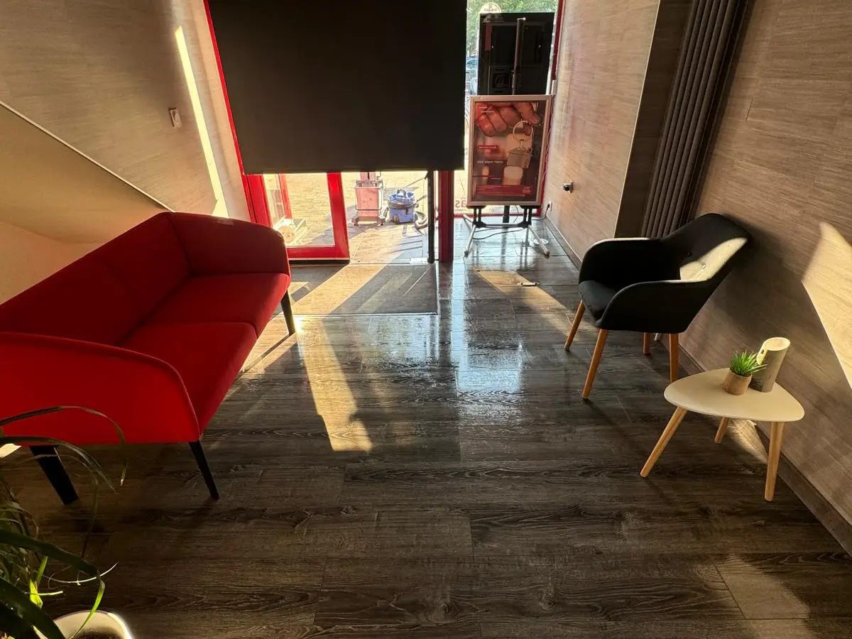 Hall d'accueil au sol brillant avec canapé rouge
