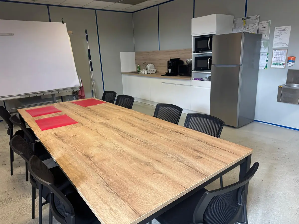 Salle de pause avec grande table en chêne et kitchenette