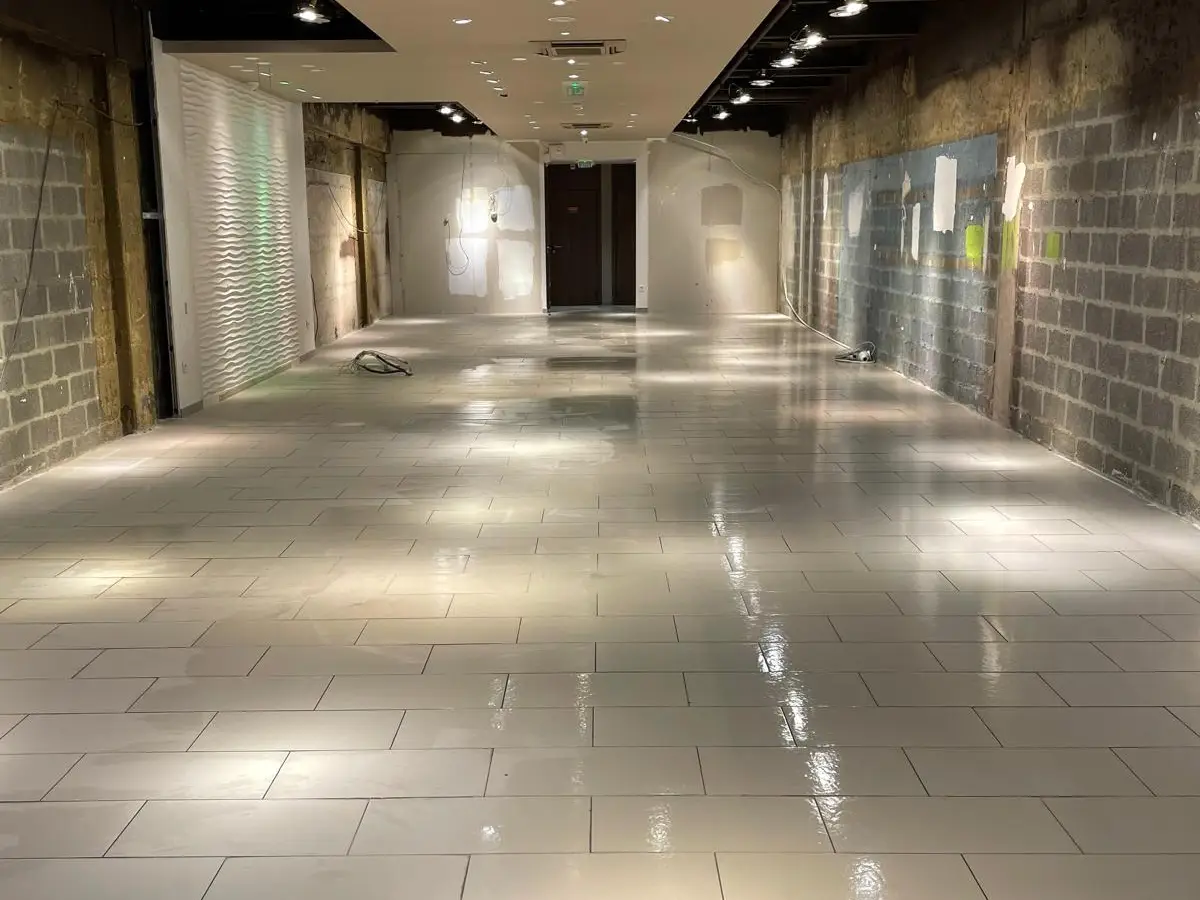 Même local commercial, sol carrelé brillant après nettoyage
